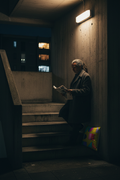 Dark estate stairwell landing at night, Pac-Man Lime cushion on the concrete step